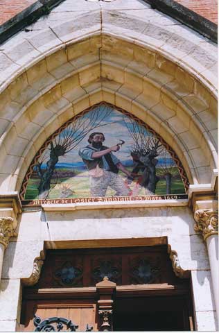 The bleeding willow, depicted above the main entrance to the basilica at Notre-Dame-de-l'Osier.